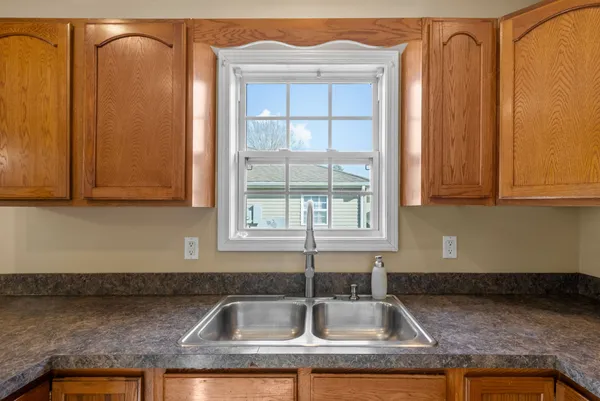 a kitchen with granite countertop white cabinets and sink