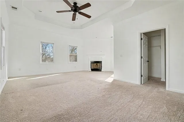 a view of a livingroom with a ceiling fan and window