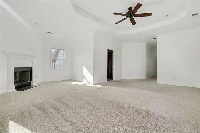 a view of a livingroom with a fireplace and a ceiling fan