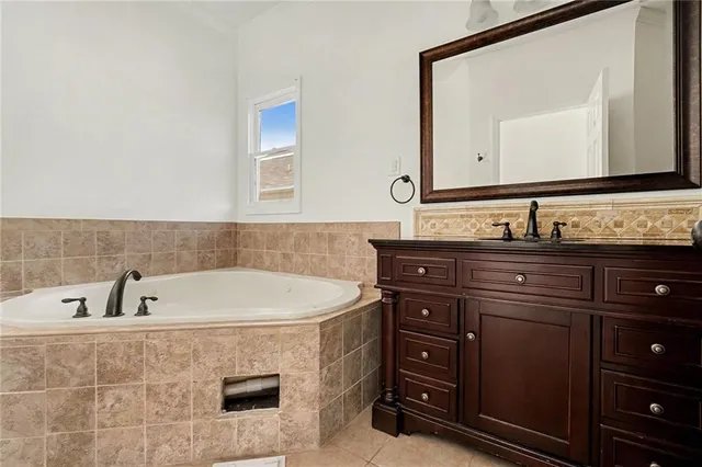 a bathroom with a sink vanity and a mirror