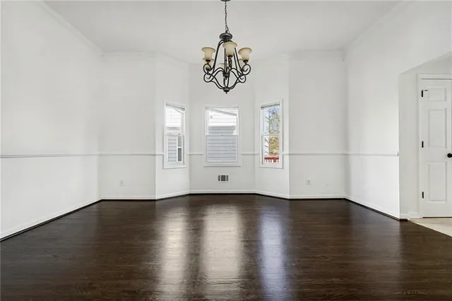 a view of a room with wooden floor