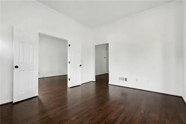 an empty room with wooden floor