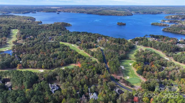 an aerial view of lake and residential houses with outdoor space