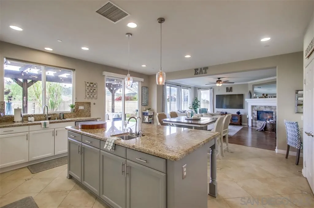 17628 Alva Road San Diego, CA 92127 - Photo 12 of 25 a kitchen with sink stove and cabinets