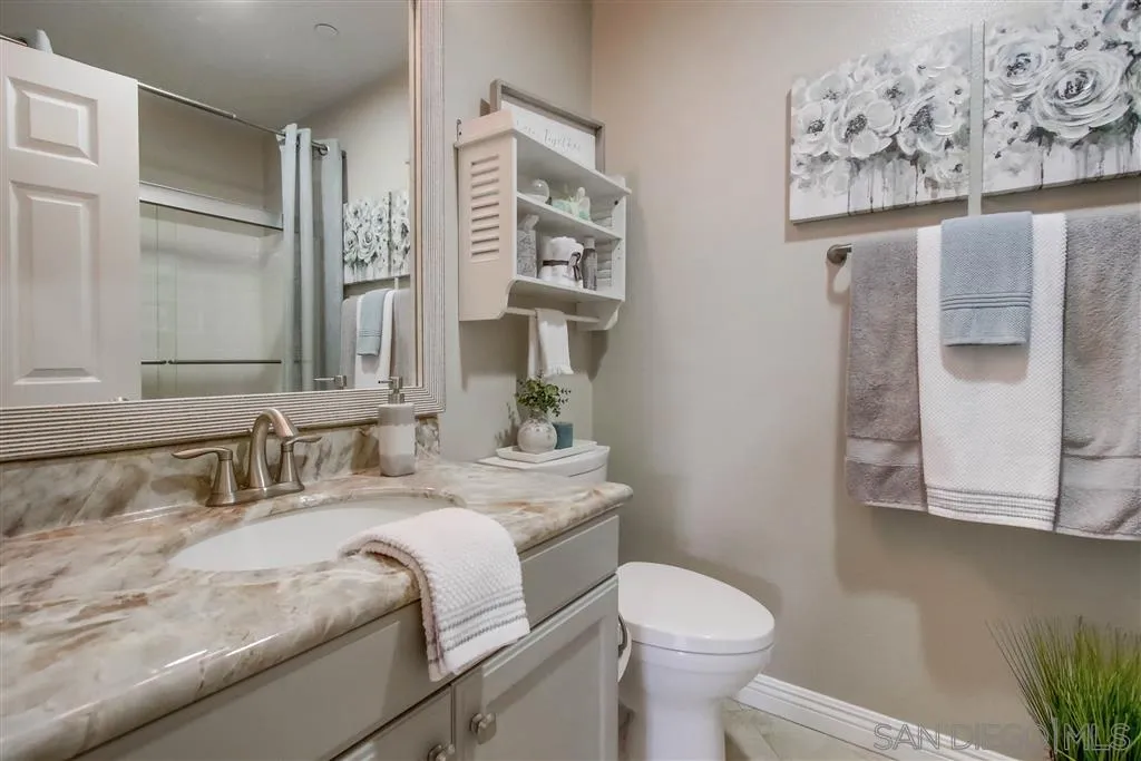 17628 Alva Road San Diego, CA 92127 - Photo 15 of 25 a bathroom with a granite countertop sink mirror vanity and toilet