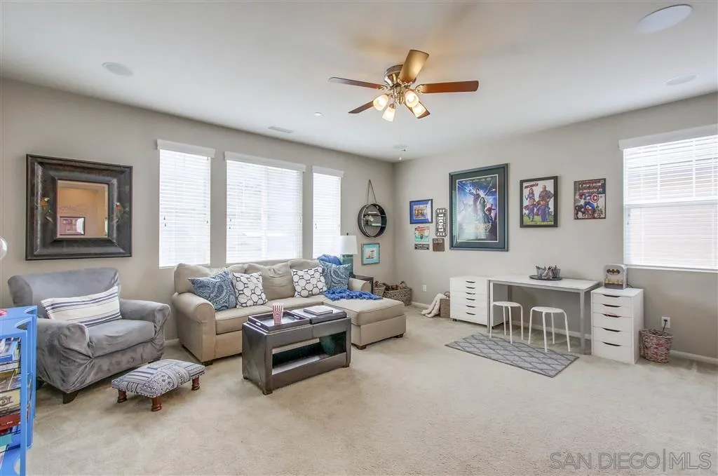 17628 Alva Road San Diego, CA 92127 - Photo 16 of 25 a living room with furniture and windows