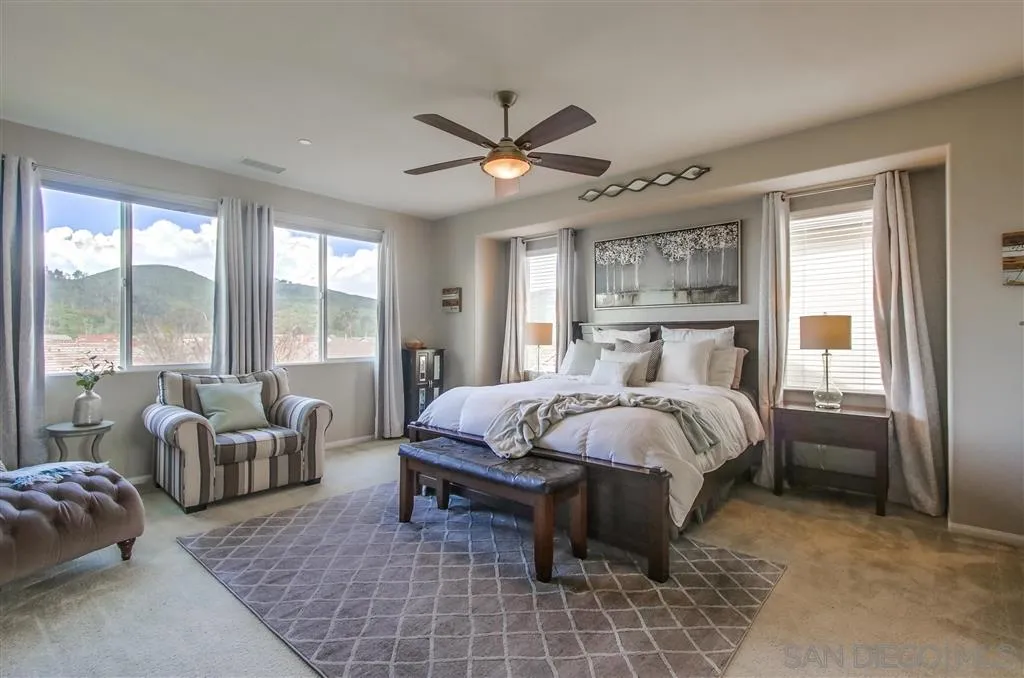 17628 Alva Road San Diego, CA 92127 - Photo 17 of 25 a bed sitting in a spacious bedroom next to a window