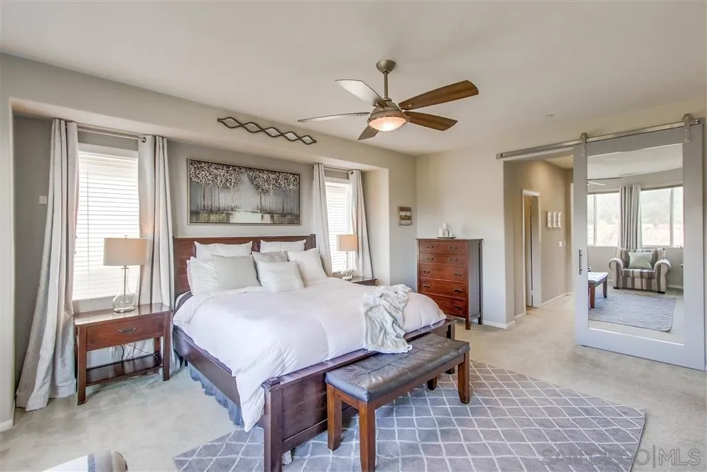 17628 Alva Road San Diego, CA 92127 - Photo 18 of 25 a bedroom with a bed and a chandelier