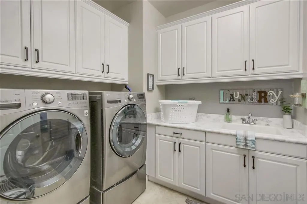 17628 Alva Road San Diego, CA 92127 - Photo 21 of 25 a utility room with sink dryer and washer