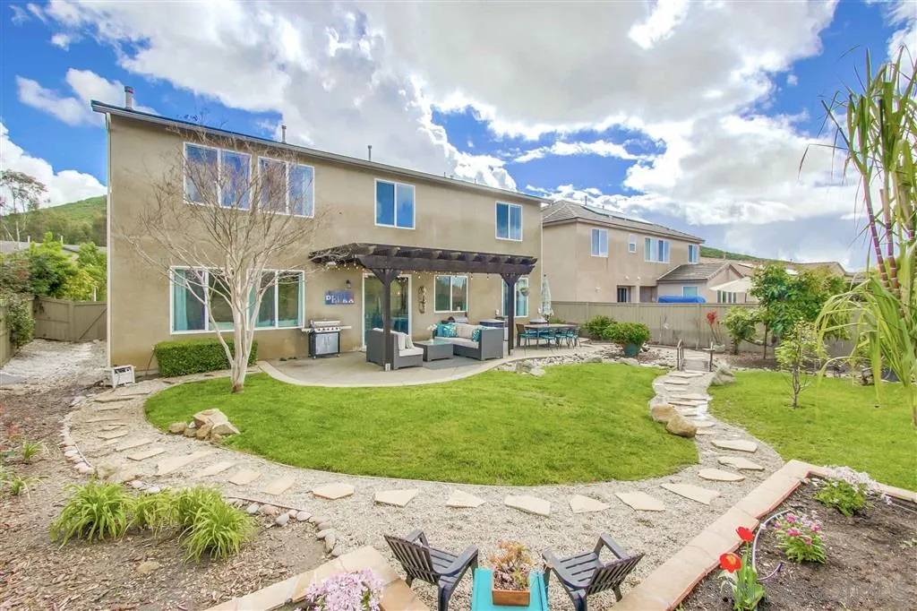 17628 Alva Road San Diego, CA 92127 - Photo 25 of 25 a front view of a house with garden