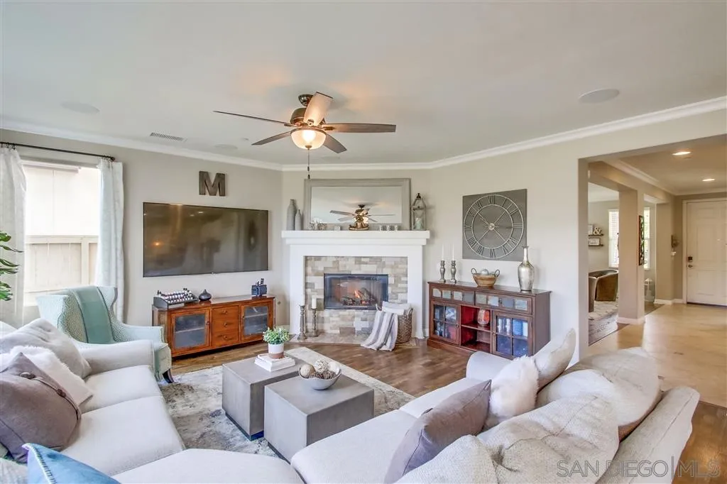17628 Alva Road San Diego, CA 92127 - Photo 5 of 25 a living room with furniture a fireplace and a flat screen tv