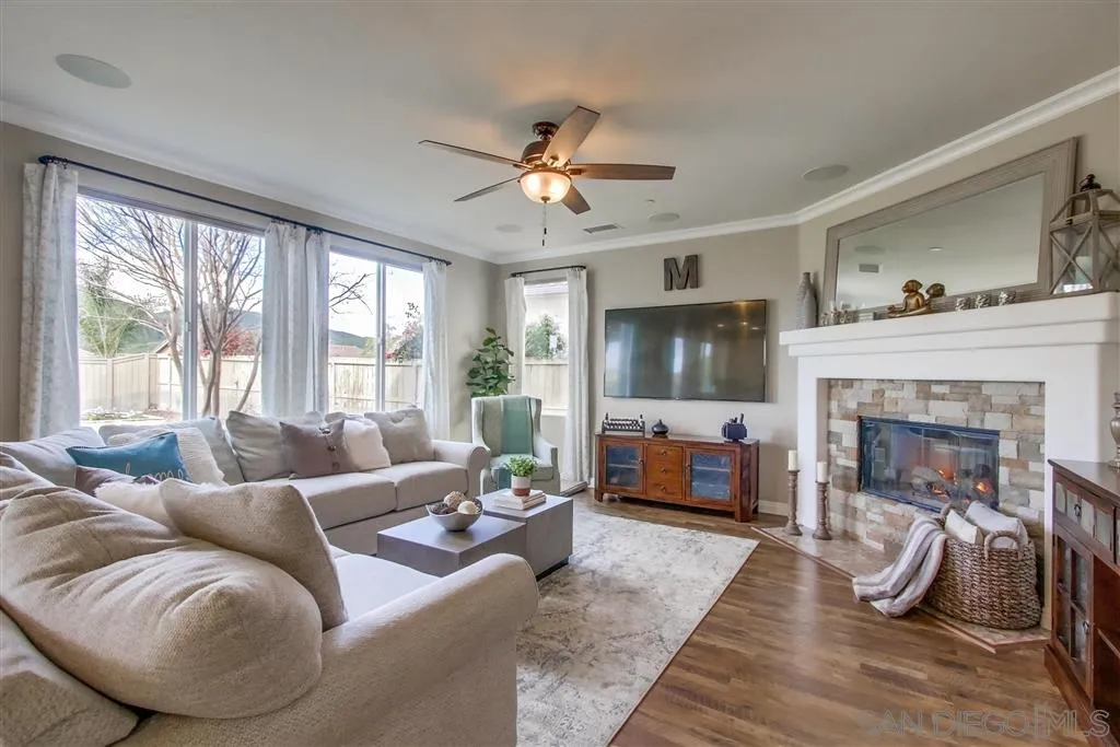 17628 Alva Road San Diego, CA 92127 - Photo 6 of 25 a living room with furniture and a fireplace