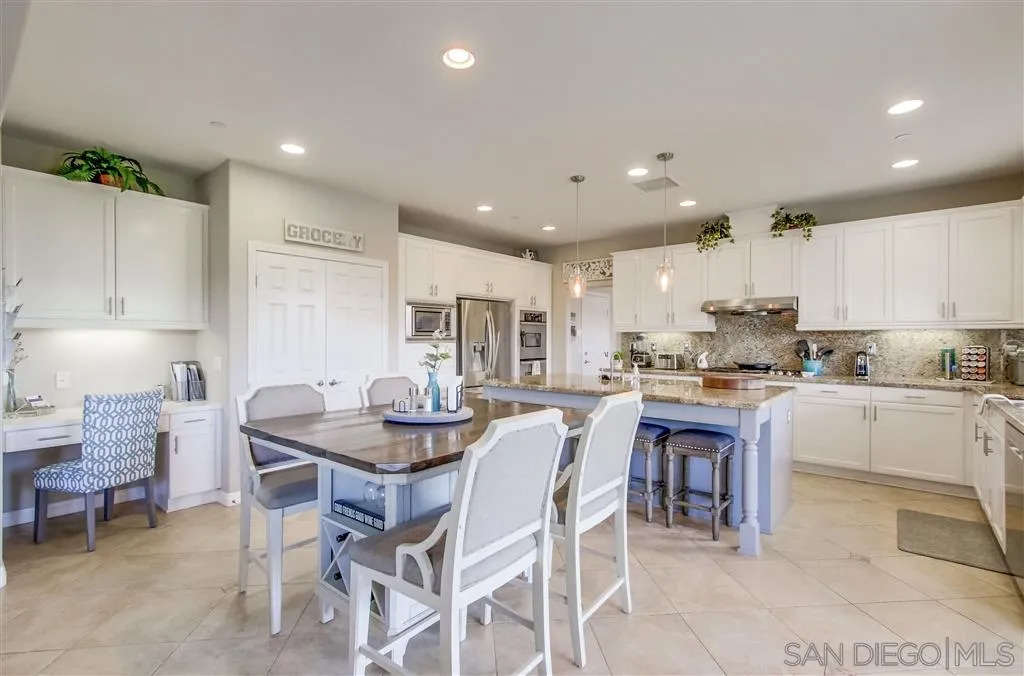 17628 Alva Road San Diego, CA 92127 - Photo 9 of 25 a kitchen with a dining table chairs and view kitchen