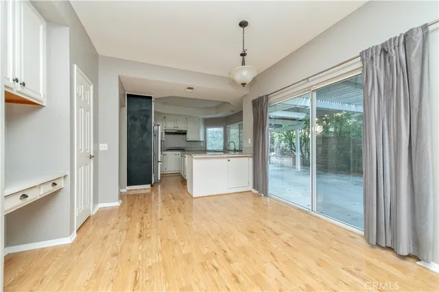 a view of a big room with windows and chandelier