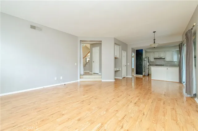 a view of an empty room with a kitchen