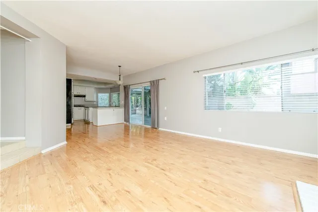 a view of empty room with a kitchen
