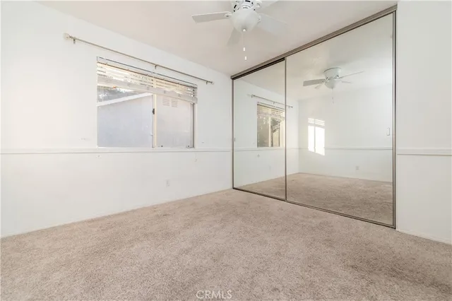 an empty room with a glass door and shower