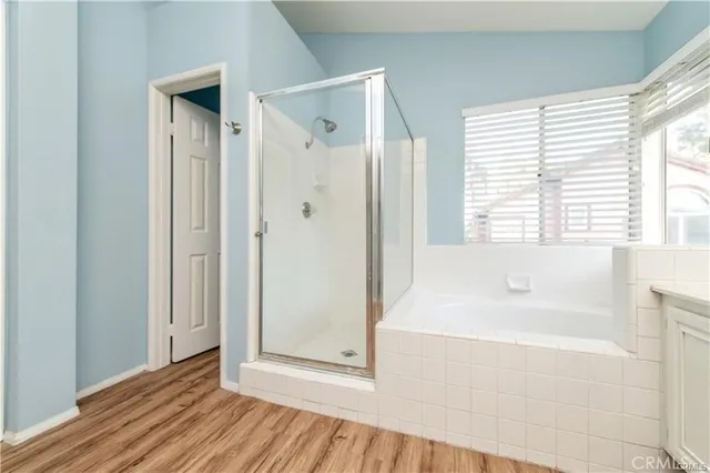 a bathroom with a bathtub and a shower