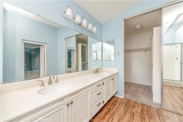a bathroom with a double vanity sink mirror and shower