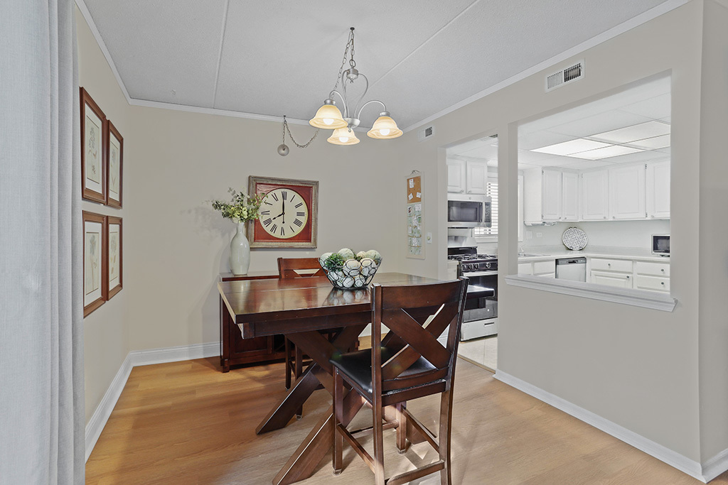 1233 Chalet Road, Unit 101 Naperville, IL 60563 - Photo 3 of 17 a view of a dining room with furniture and chandelier