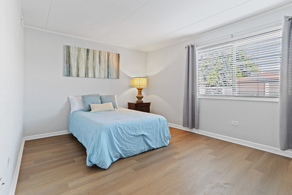 1233 Chalet Road, Unit 101 Naperville, IL 60563 - Photo 9 of 17 a bedroom with a bed and a window