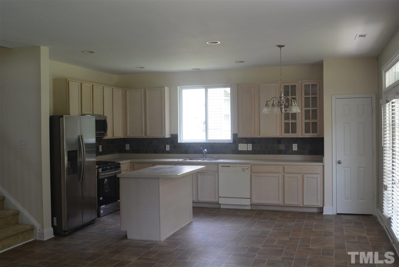 2406 Quarry Ridge Lane Raleigh, NC 27610 - Photo 4 of 11 Kitchen has new refrigerator (which conveys), new microwave, and new gas stove.
