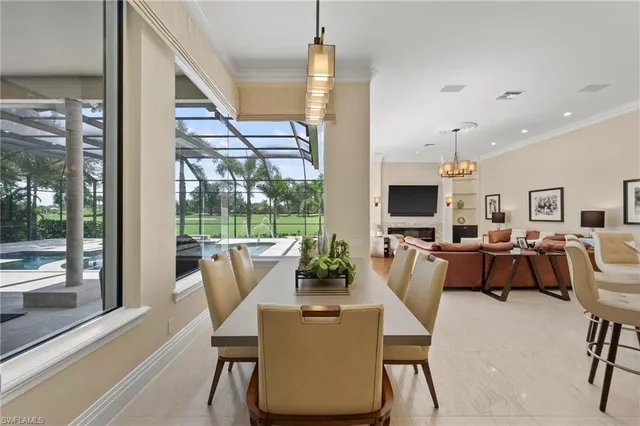 a dining room with furniture wooden floor and a chandelier