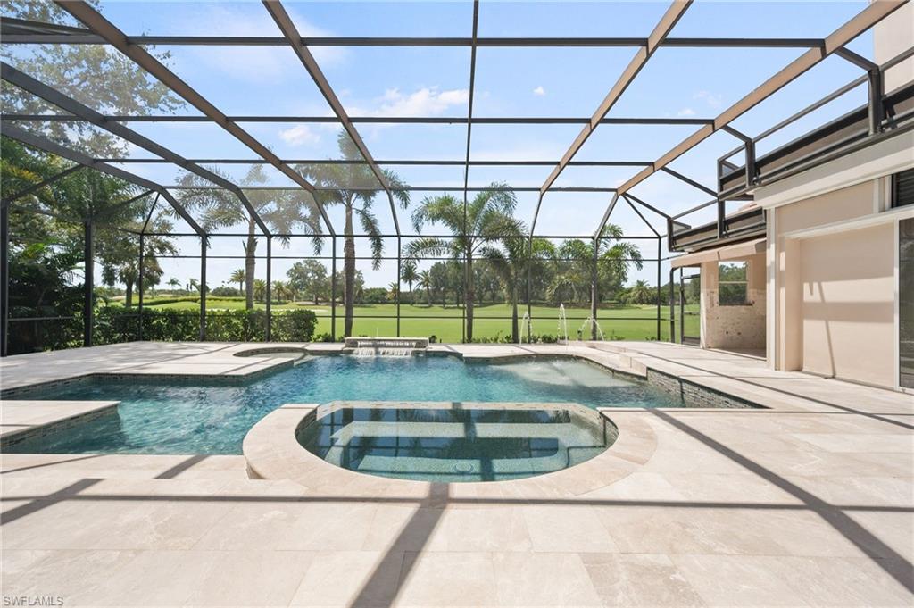 13700 Pondview Circle Naples, FL 34119 - Photo 2 of 49 View of pool with a sunroom, a patio, a pool with connected hot tub, and a lanai