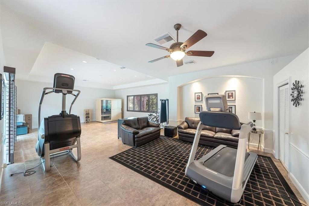 13700 Pondview Circle Naples, FL 34119 - Photo 27 of 49 Workout room featuring a raised ceiling and a ceiling fan