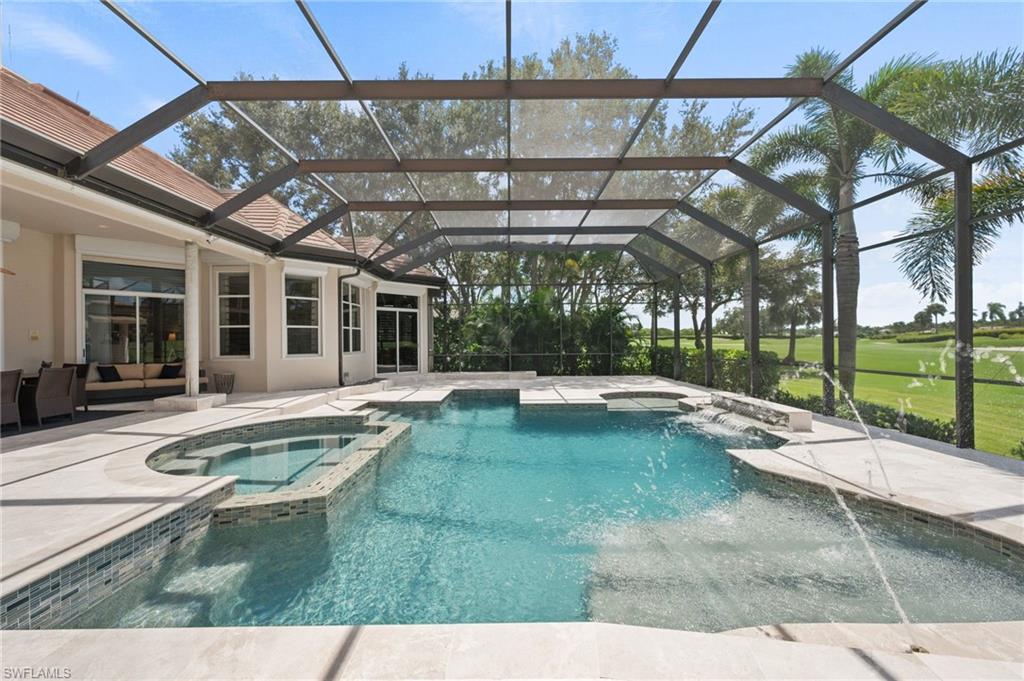 13700 Pondview Circle Naples, FL 34119 - Photo 32 of 49 View of pool with a pool with connected hot tub, a sunroom, a patio, glass enclosure, and view of golf course