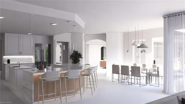 a kitchen with stainless steel appliances kitchen island granite countertop a refrigerator and cabinets