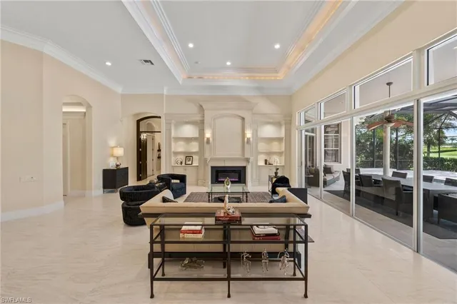 a living room with fireplace furniture and a large window