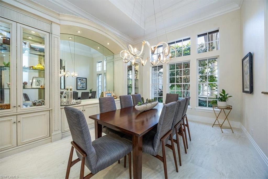 13700 Pondview Circle Naples, FL 34119 - Photo 8 of 49 Dining area with a chandelier, ornamental molding, a high ceiling, and recessed lighting