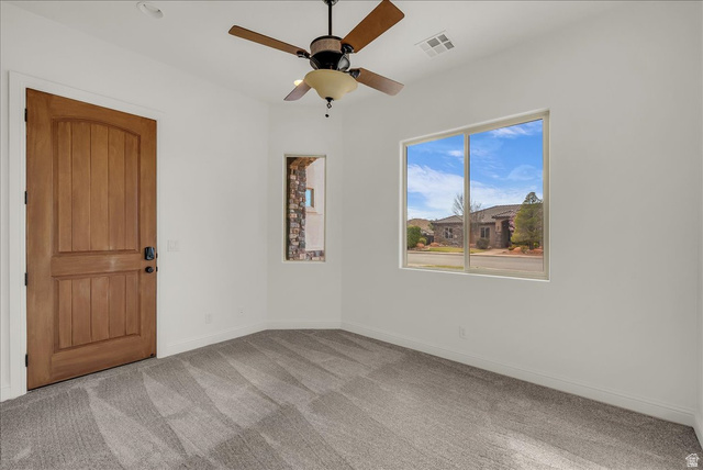 691 Rainier Drive St. George, UT 84770 - Photo 9 of 24 Unfurnished room with light colored carpet and a ceiling fan