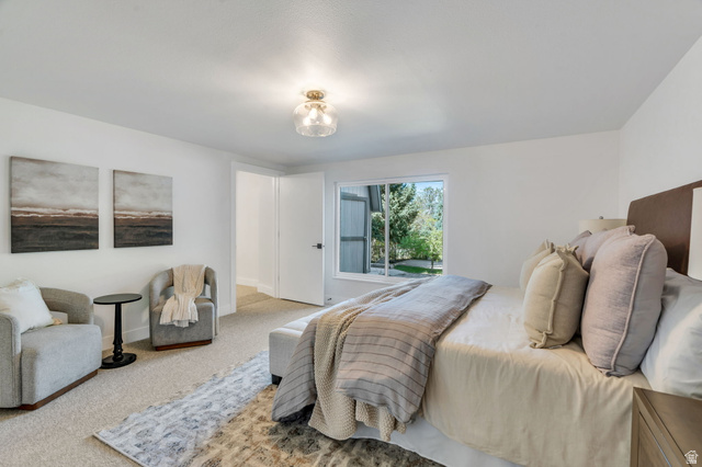 3813 North Foothill Drive Provo, UT 84604 - Photo 20 of 71 Carpeted bedroom featuring a window with exterior landscaping views, a ceiling-mounted light fixture, and white painted walls