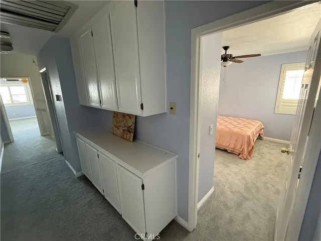 a bedroom with a bed next to a window