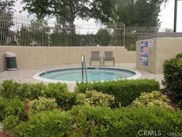 a view of a swimming pool with an outdoor space and seating area