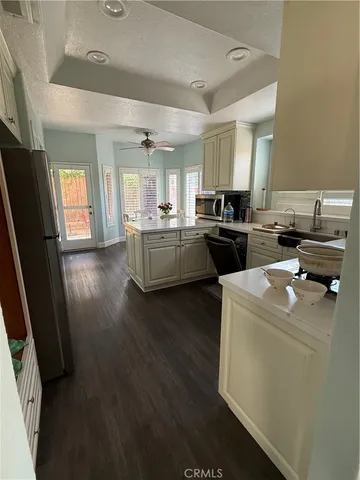a kitchen with sink refrigerator and stove