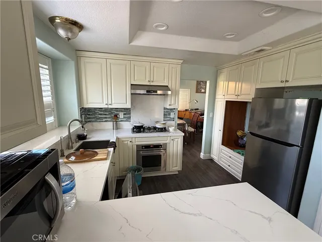 a kitchen with a refrigerator stove and sink