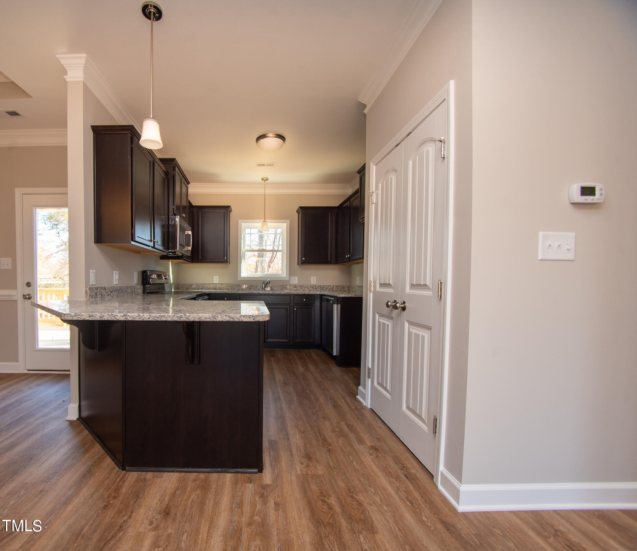 57 Waters Edge Drive Erwin, NC 28339 - Photo 29 of 59 a kitchen with kitchen island granite countertop wooden floors and wide window