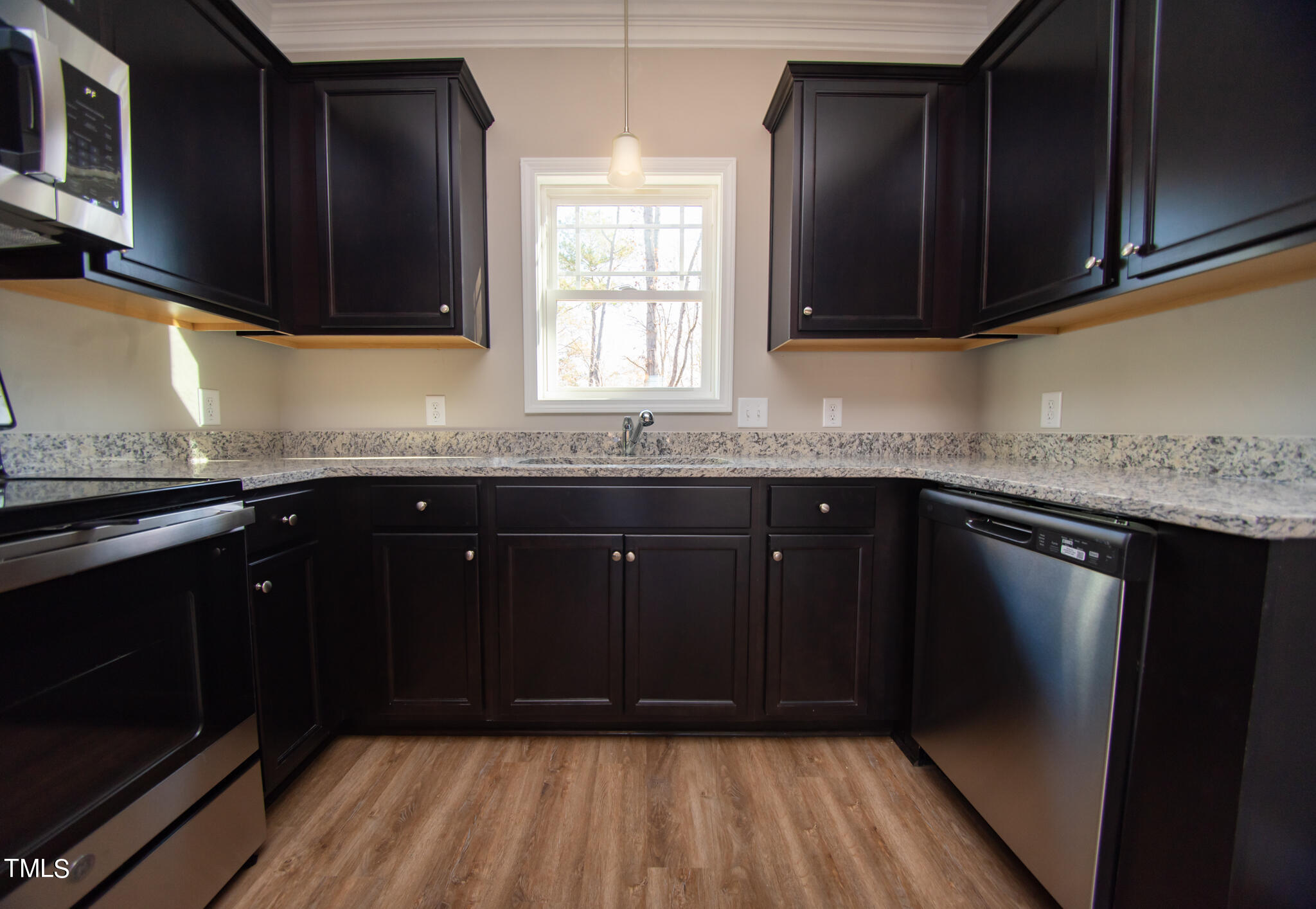 57 Waters Edge Drive Erwin, NC 28339 - Photo 30 of 59 a kitchen with granite countertop stainless steel appliances a sink stove and cabinets