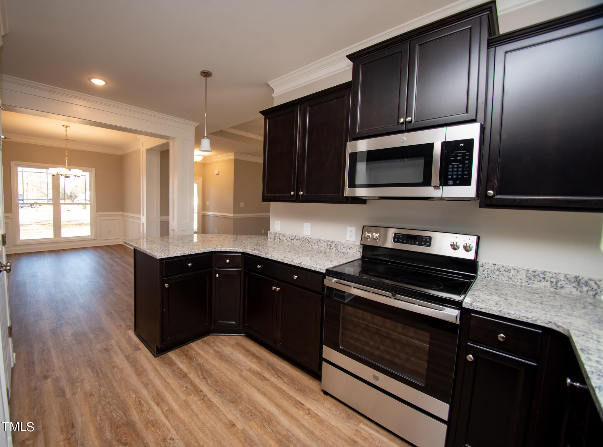 57 Waters Edge Drive Erwin, NC 28339 - Photo 32 of 59 a kitchen with wooden cabinets and black stainless steel appliances