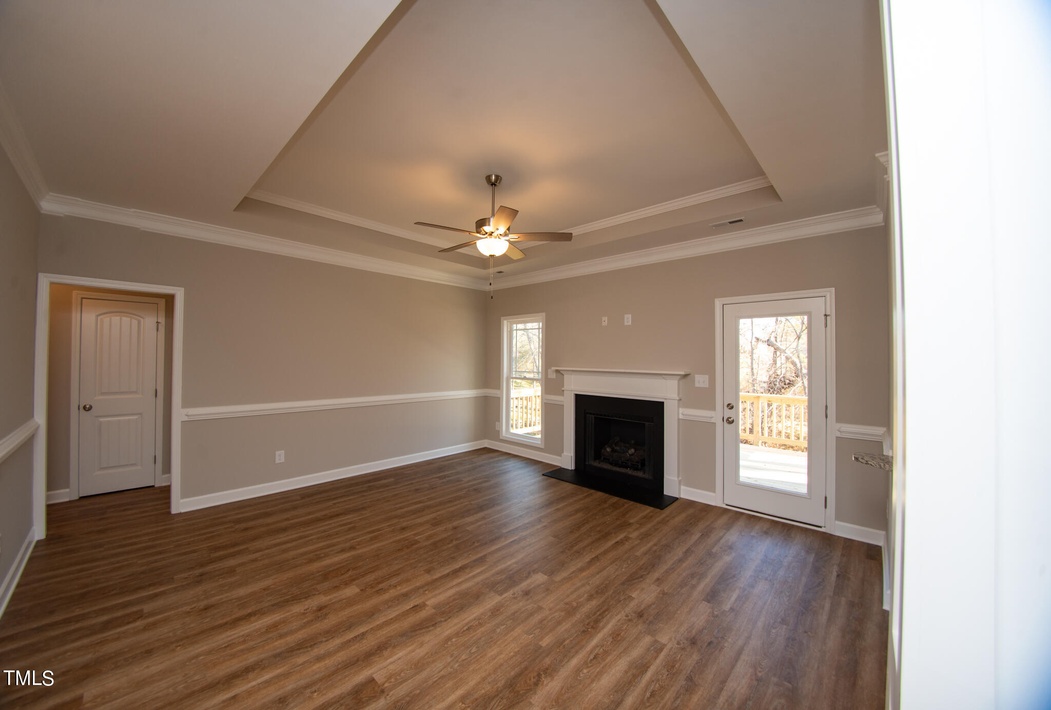 57 Waters Edge Drive Erwin, NC 28339 - Photo 34 of 59 an empty room with wooden floor fireplace and windows