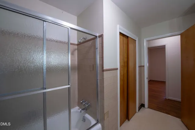 a bathroom with a shower and a glass door