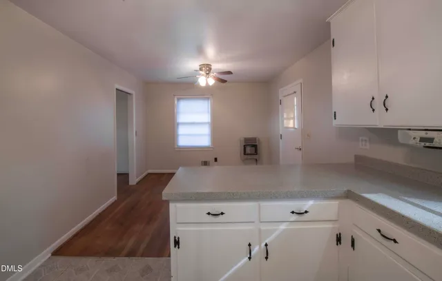 a kitchen with a sink cabinets and window