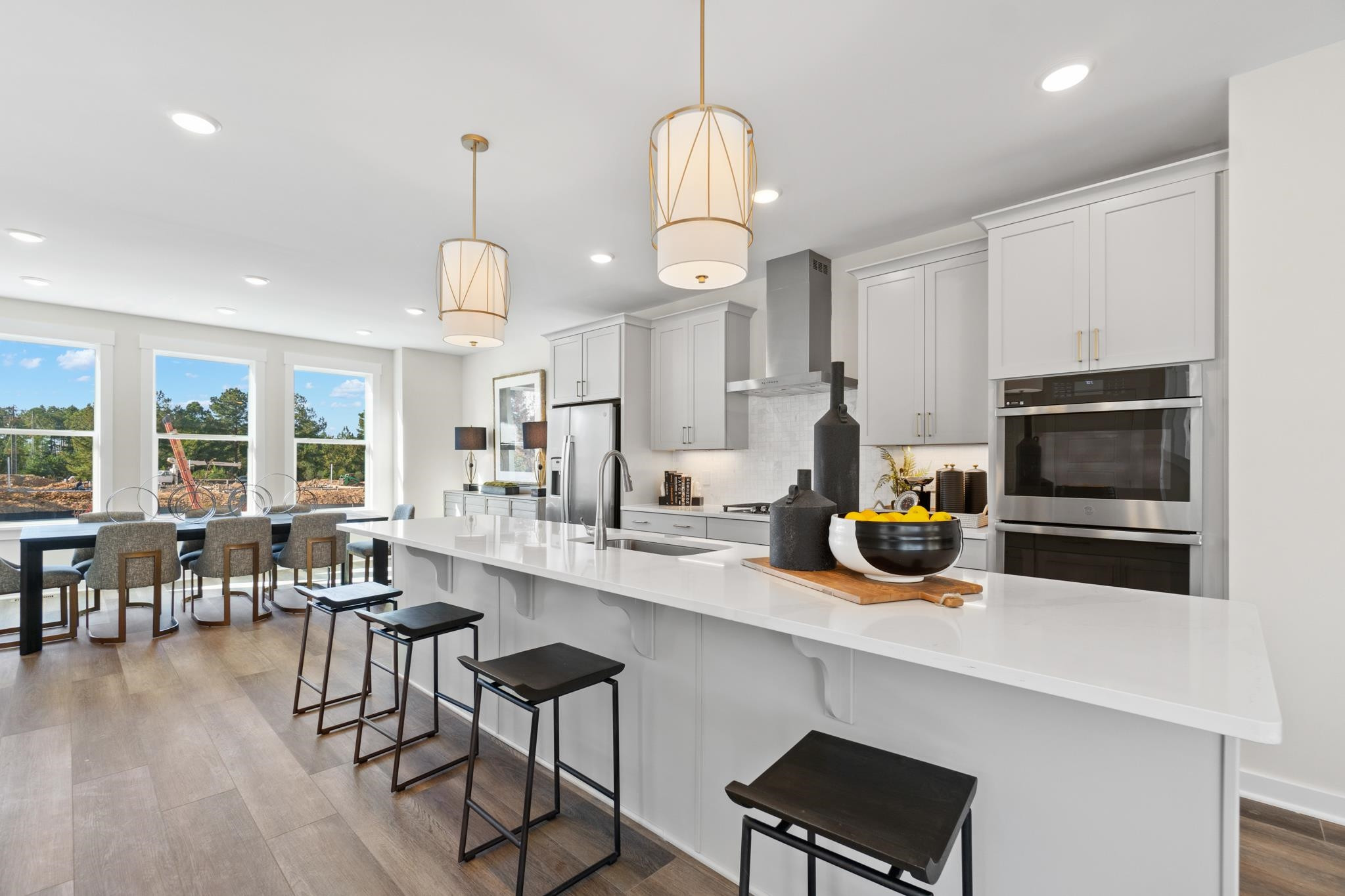 1900 Fahey Drive Apex, NC 27502 - Photo 1 of 2 a kitchen with stainless steel appliances a dining table chairs stove and cabinets
