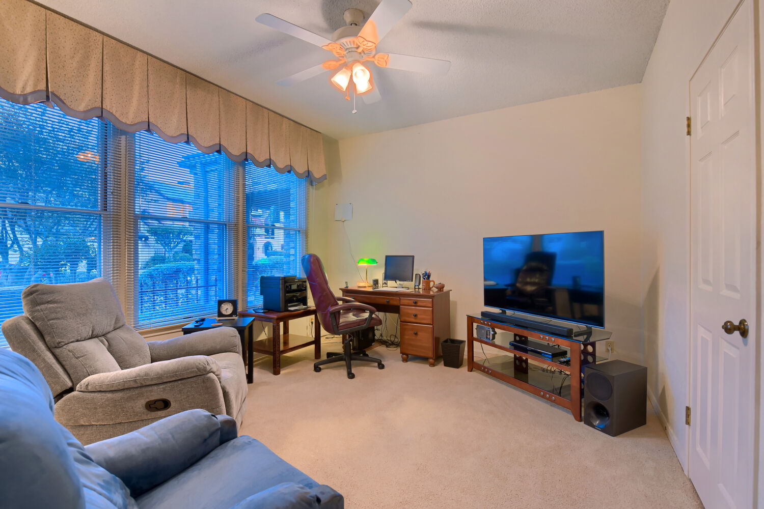 10904 Legends Lane Austin, TX 78747 - Photo 27 of 36 a living room with furniture a flat screen tv and a window