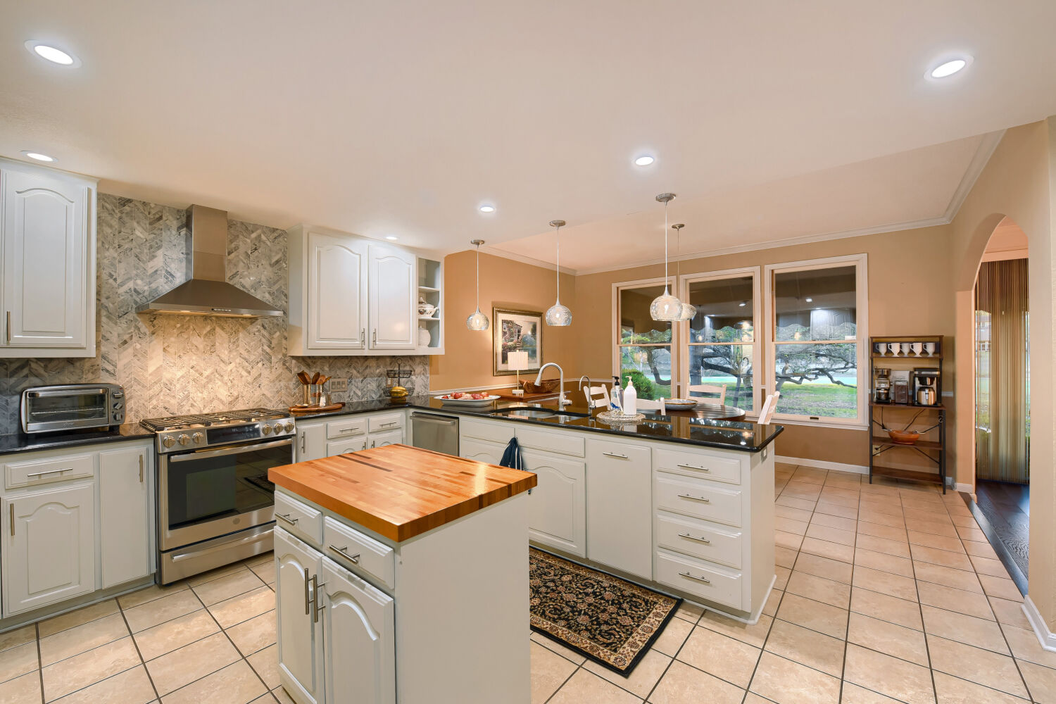 10904 Legends Lane Austin, TX 78747 - Photo 9 of 36 a kitchen with a stove a sink a refrigerator and cabinets