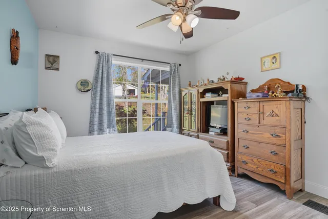 a spacious bedroom with a bed and a chandelier