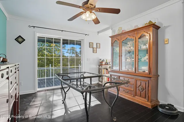 a view of a livingroom with furniture a window and wooden floor